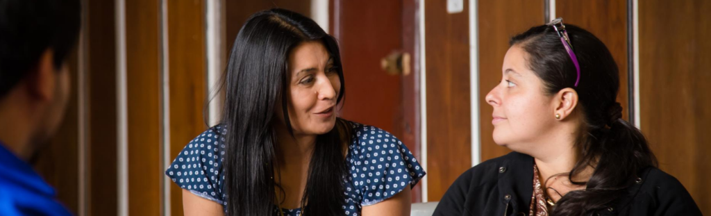 Two women talking in a refugee women's empowerment group